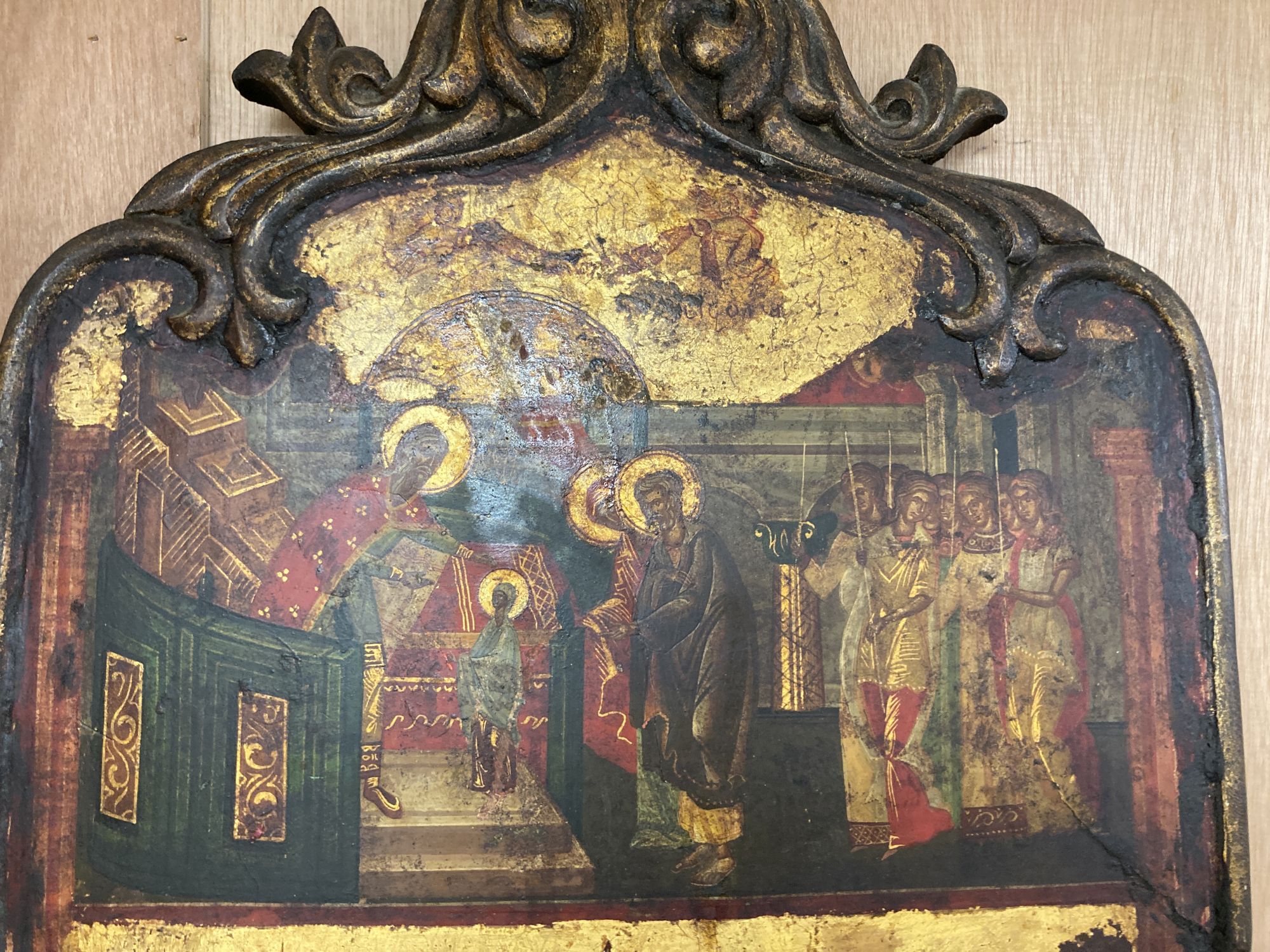 A tempera on panel icon with two scenes from the bible, shaped, overall 54 x 36.5cm
